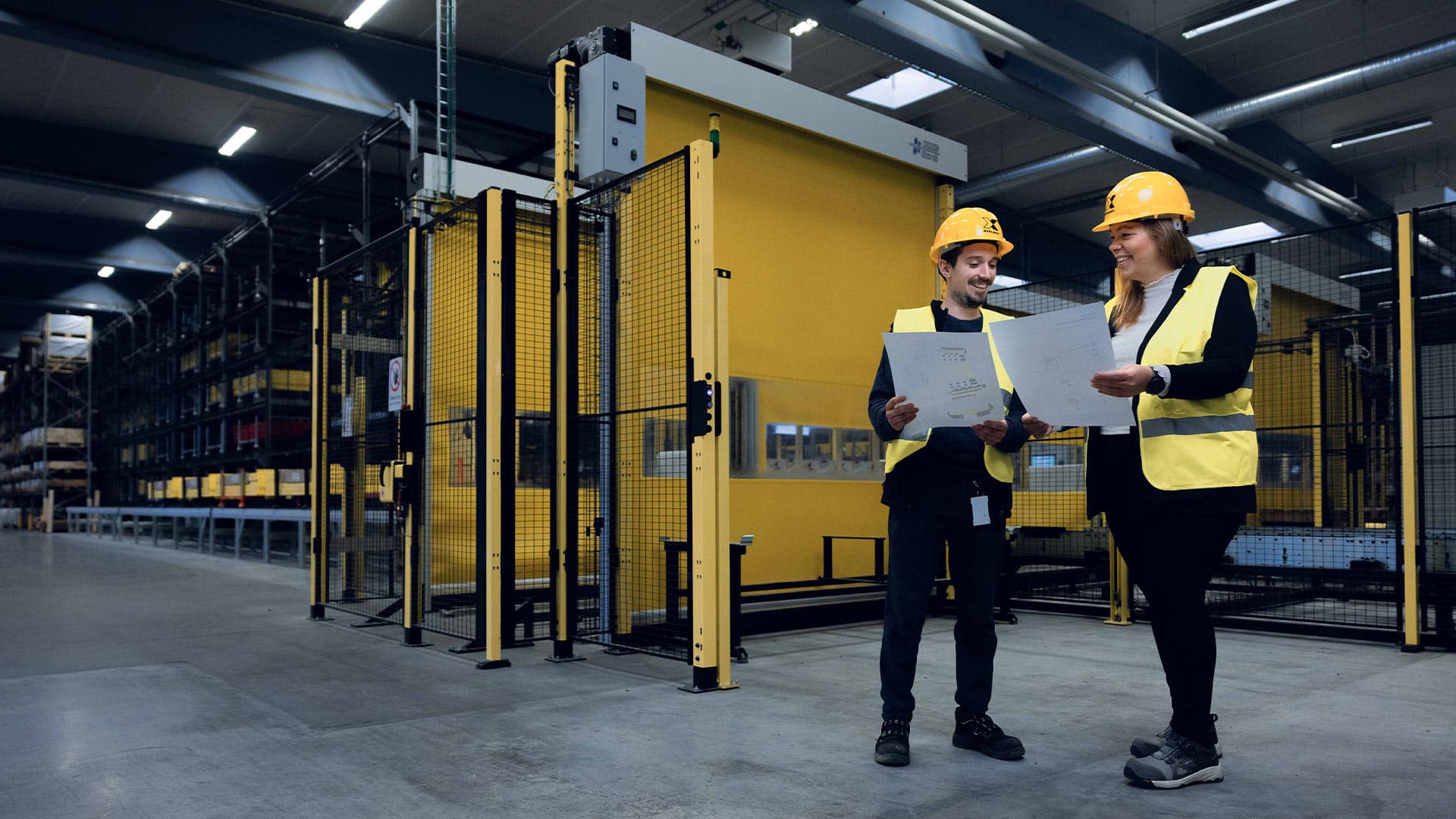 Industrial engineers discussing safety in a warehouse environment