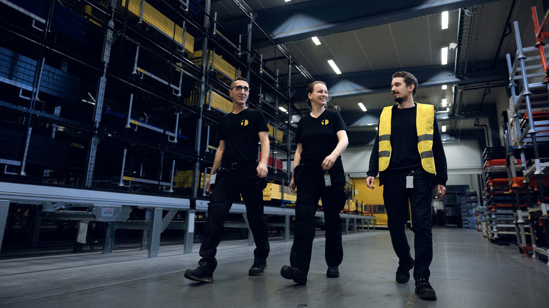 Employees working together in a warehouse environment, representing teamwork and daily operations