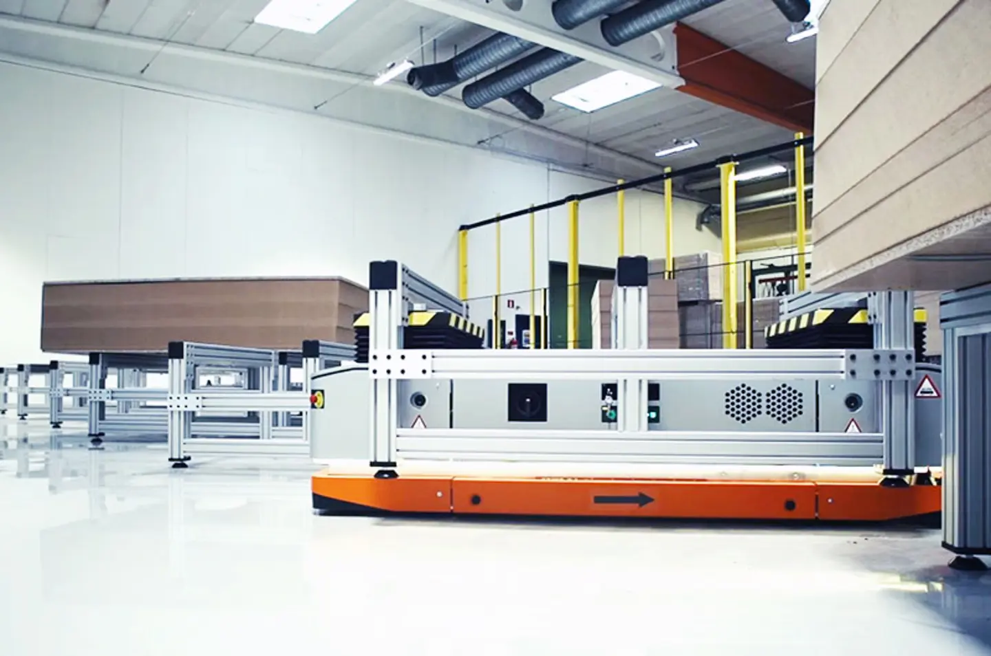 Autonomous mobile robot (AMR) transporting materials and safety fencing along the sides