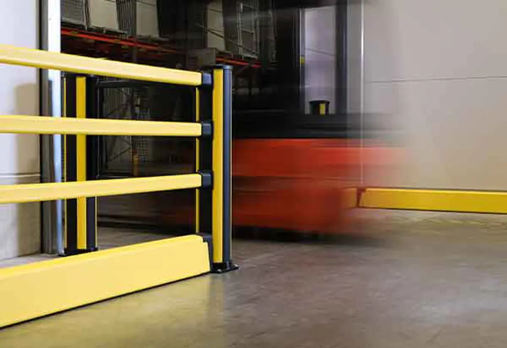 Three different black and yellow impact protection configurations, one bollard, one pedestrian with floor barrier configuration and one standalone floor barrier in close proximity to a traffic route where a forklift is driving through a doorway