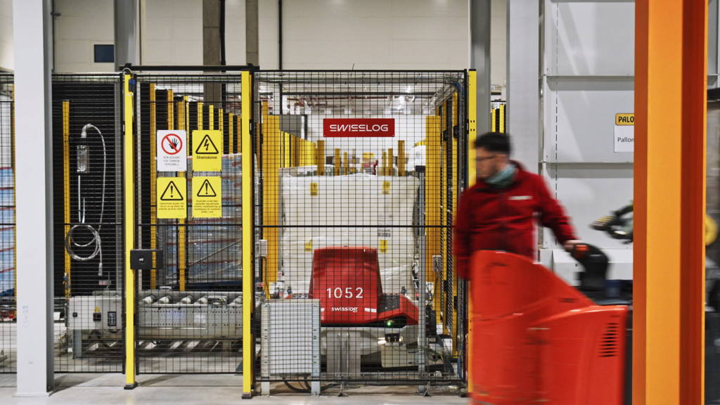 Axelent's safety fences in a warehouse with a person standing next to it