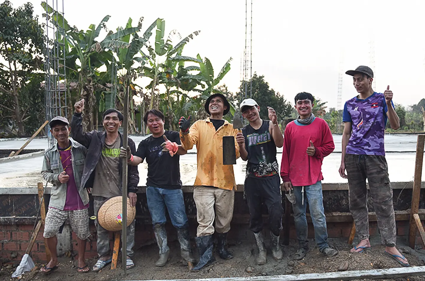 Construction workers standing in front of the new building at Touk för Livet’s family home in Laos