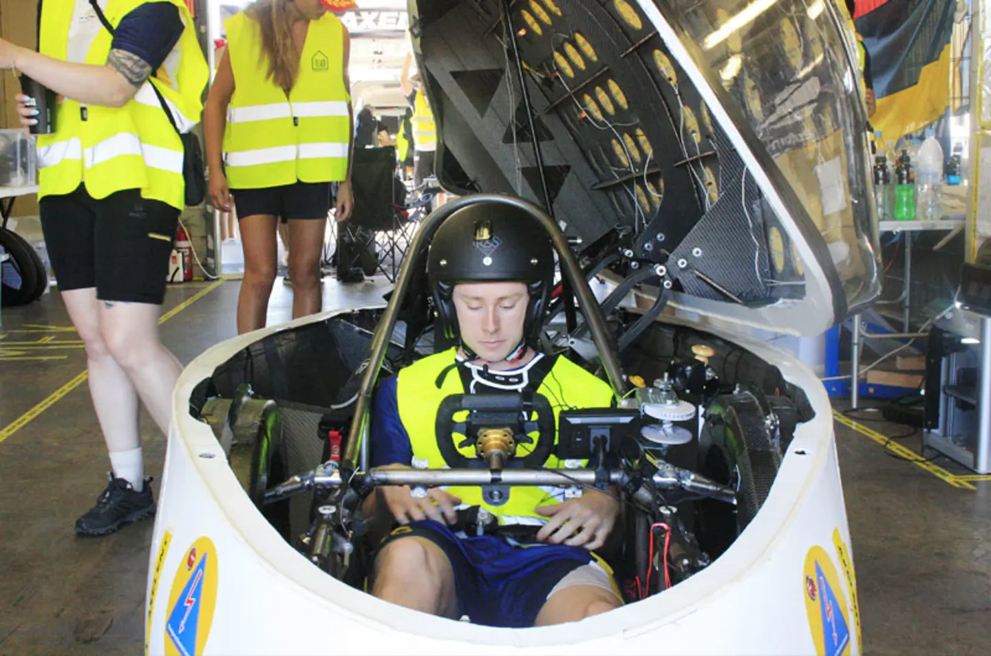 Driver Nils Persson sitting in the solar car Nova Lumia in a garage