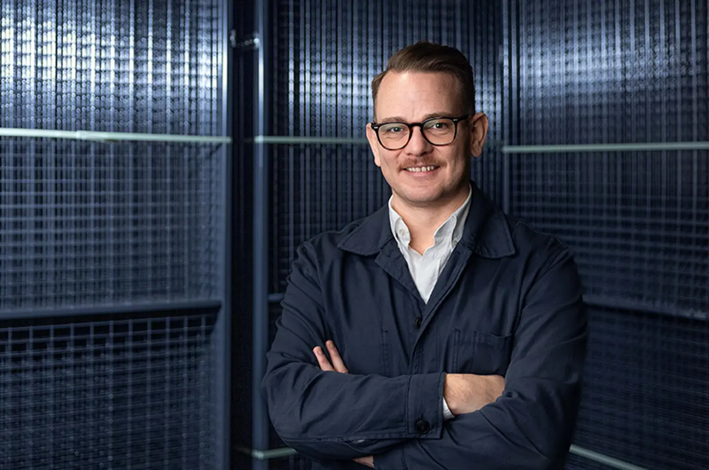 Axelents Cheif Product Officer Daniel Häggström in front of mesh panels
