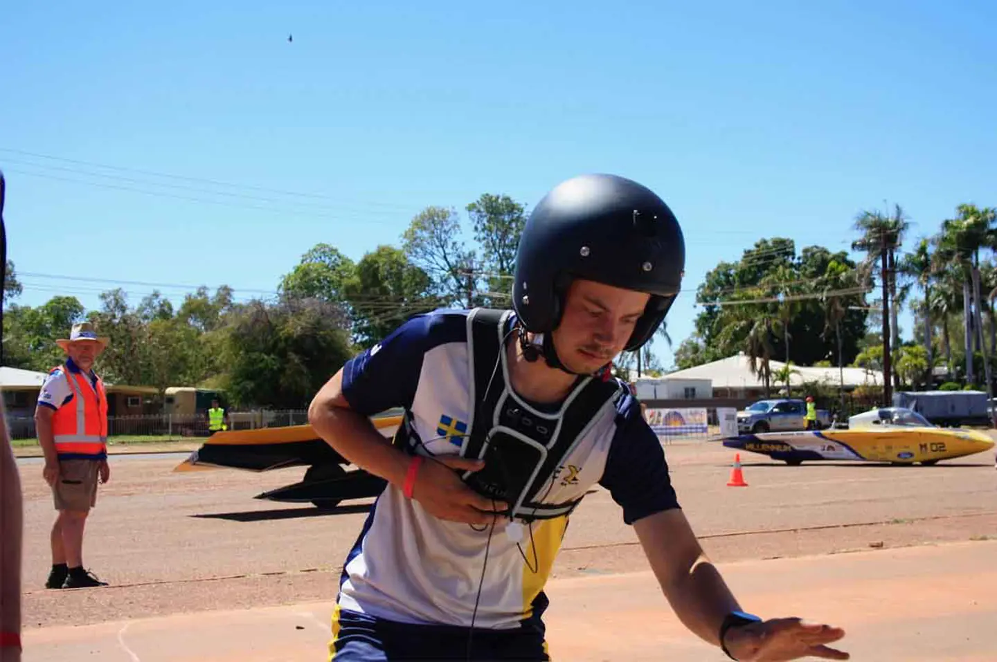 Member of JU Solar Team pressing the "start the time" button at a control stop